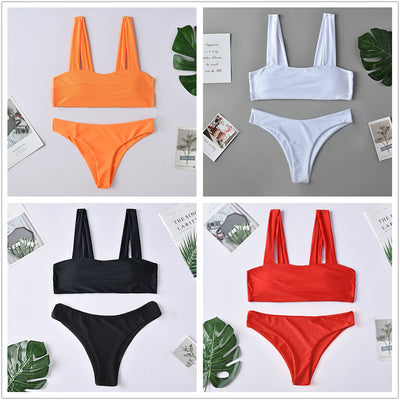 Dark green two-piece swimsuit with a bandeau top featuring horizontal ruching and high-cut bikini bottoms.
