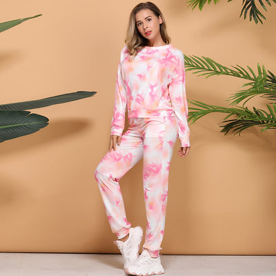 Woman wearing a pink and white tie-dye long-sleeve top and matching pants set, posing casually. - Image 12