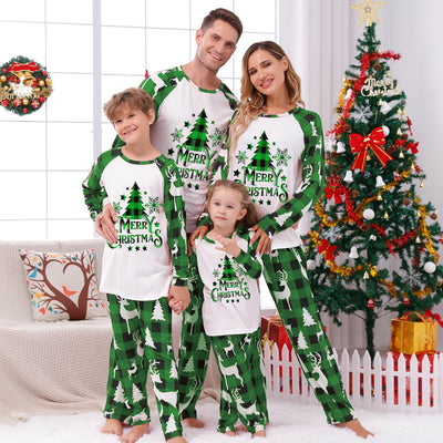Matching family Christmas pajamas in green and white plaid with deer and Christmas tree graphics.