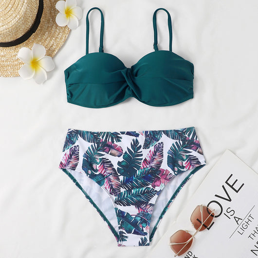 Teal twisted bandeau bikini top with tropical leaf print high-waisted bottoms on a model wearing a white shirt. - Image 19