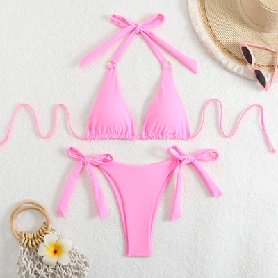 Black two-piece swimsuit with a halter triangle top and high-cut tie-side bottoms featuring gold-tone rings. - Image 8