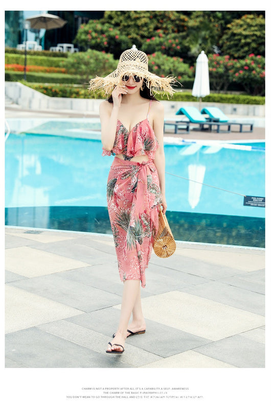 Pink tropical print three-piece women's swimwear set with ruffled bikini top, high-waisted bottoms, and matching sarong. - Image 15