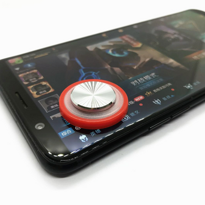 Pink and silver mobile game joystick attached to a black smartphone displaying a game on its screen. - Image 14