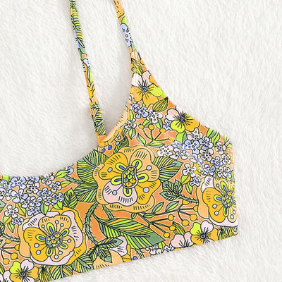 New printed bikini swimsuit with a vibrant floral pattern on a light blue background, featuring a scoop neck top and high-cut bottom. - Image 14