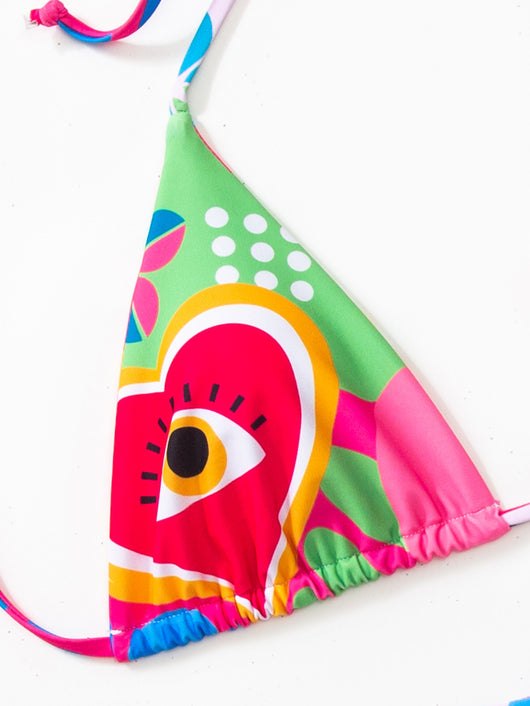 Women's vibrant abstract eye print bikini with triangle top and tie-side bottoms, featuring pink, green, and blue. - Image 10