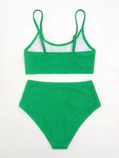 Woman in a solid green textured high-waisted bikini, holding a disposable camera on a sunny beach. - Image 11