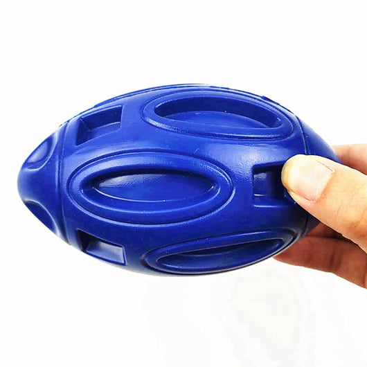 Green rubber rugby-shaped dog toy with textured surface and cut-outs, designed for chewing and play. - Image 3