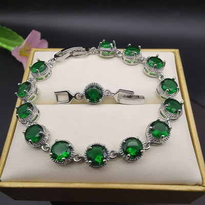 Four-piece silver-tone jewelry set with round green gemstones, including a necklace, bracelet, ring, and dangle earrings. - Image 24
