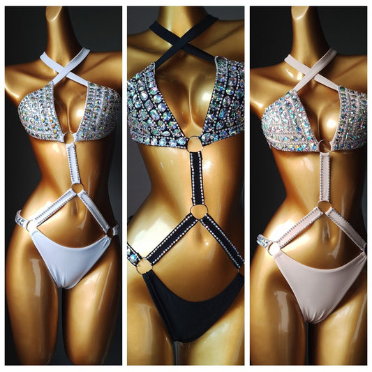 White rhinestone bikini with triangle tops, high-cut bottoms, and silver-toned O-rings and chains.