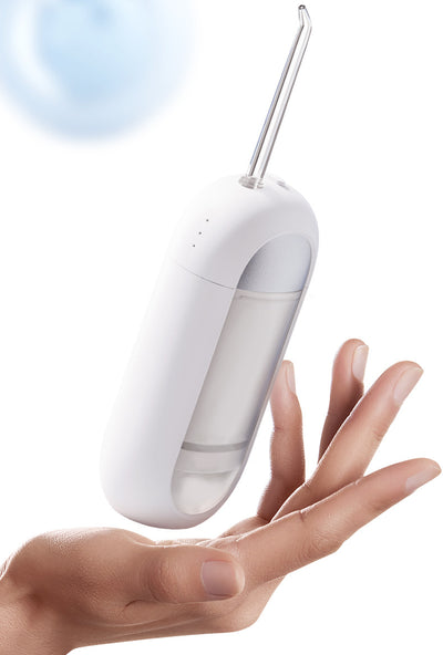 White portable electric dental water flosser with a clear nozzle and retractable water tank for oral hygiene. - Image 24