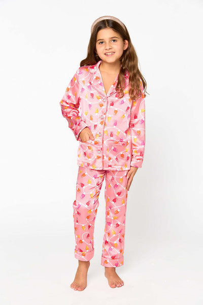 Young girl in a leopard print pajama set with black feather trim on the cuffs and ankles, wearing a pink glitter headband. - Image 11