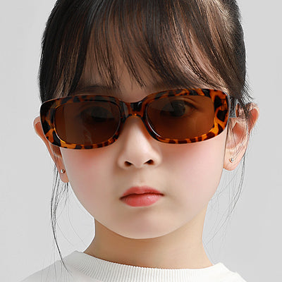 Children's small frame oval sunglasses with a solid white PC frame and brown AC lenses for UV protection.