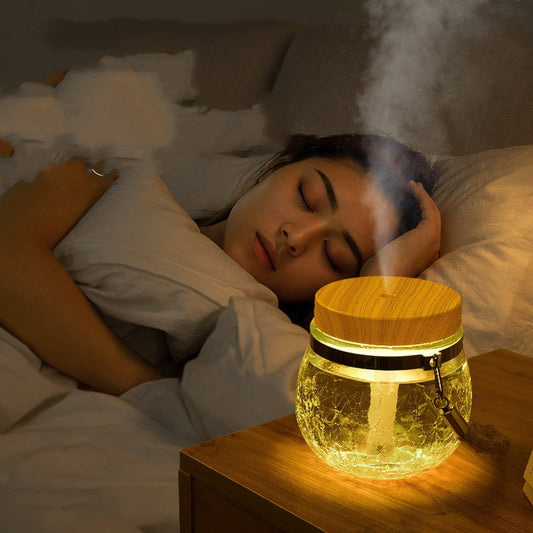 Desktop humidifier with a clear, crackled glass base, white lid, and a brown rope handle. - Image 2