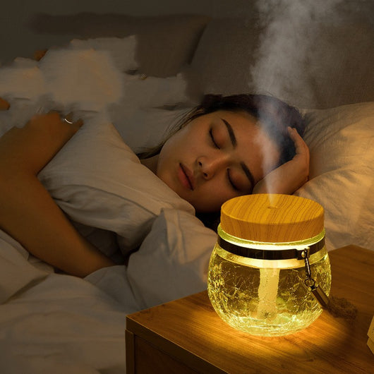 Desktop humidifier with a clear, crackled glass base, white lid, and a brown rope handle. - Image 2
