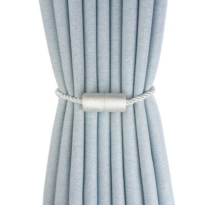 Black cylindrical magnetic curtain tieback holding a light blue pleated curtain, against a clean white background. - Image 5