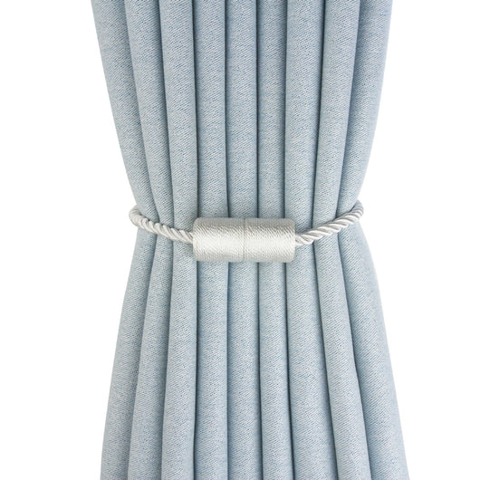 Black cylindrical magnetic curtain tieback holding a light blue pleated curtain, against a clean white background. - Image 5