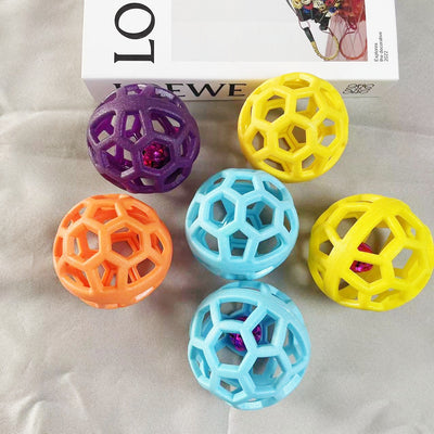Orange TPR hollow lattice dog chew ball with a shiny pink bell ball inside for interactive pet play. - Image 3