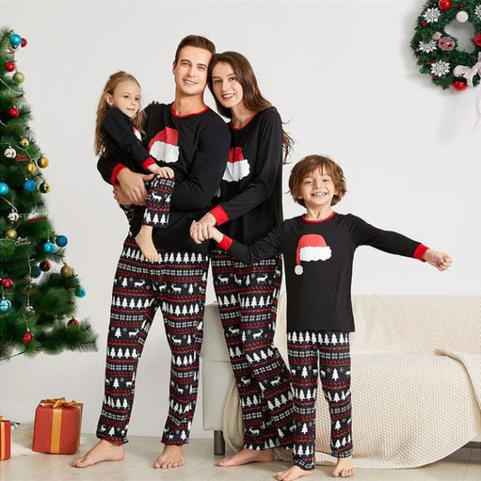 Black long-sleeve Christmas pajama top with a red Santa hat graphic and matching pants with a reindeer and tree pattern.