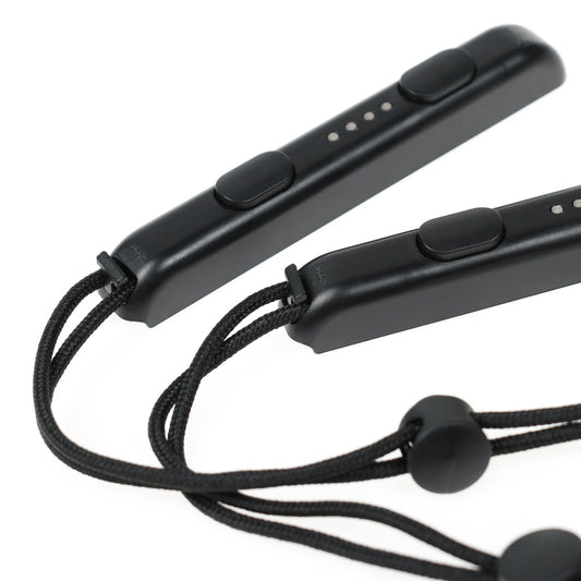 Two black Nintendo Switch Joy-Con wrist straps, one showing internal metal rail, the other with buttons and lanyard. - Image 2