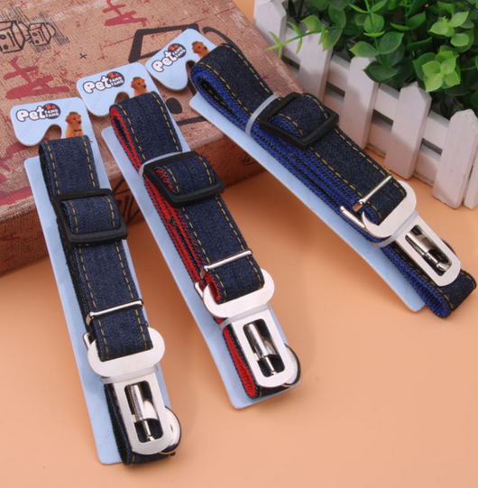 Dark blue denim pet car seat belt with yellow stitching, metal buckle, and plastic adjuster on a hanger. - Image 2