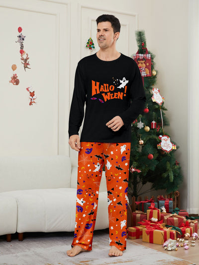 Family of four wearing matching black and orange Halloween long-sleeve pajamas with ghost and bat prints. - Image 20