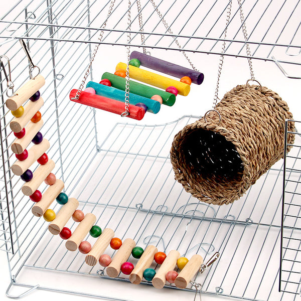 Small animal cage accessories including a flexible wooden ladder with colorful beads, a colorful wooden swing, and a woven grass tunnel.
