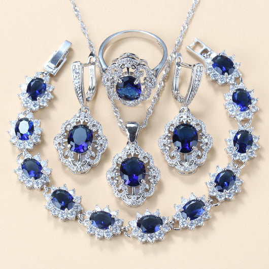 Four-piece jewelry set with silver-tone settings, featuring oval purple cubic zirconia stones surrounded by clear accents. - Image 12