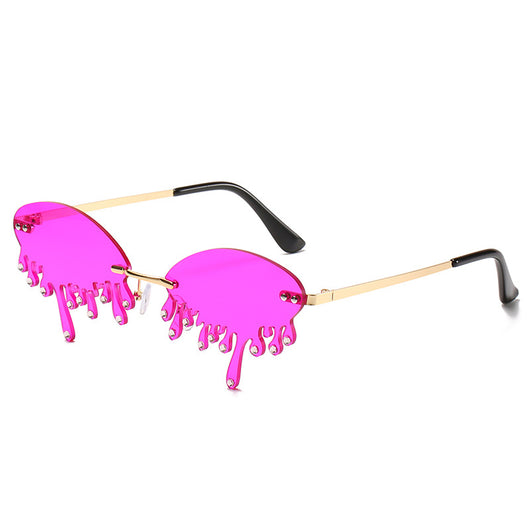 Rimless sunglasses with dark gray dripping liquid-shaped lenses, silver studs, and gold metal frames. - Image 17