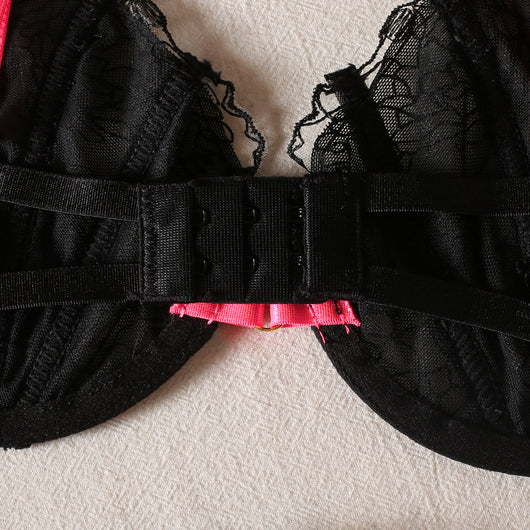 Black lace bra and thong set with hot pink harness straps, gold-tone rings, and a matching hot pink choker. - Image 8