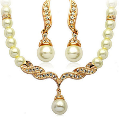 Elegant pearl necklace and matching drop earrings set with sparkling crystal accents, ideal for bridal wear.