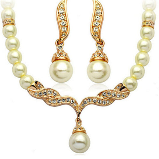 Elegant pearl necklace and matching drop earrings set with sparkling crystal accents, ideal for bridal wear.