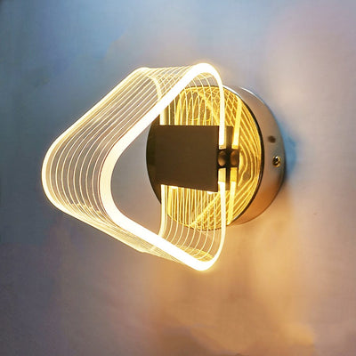 Modern simple LED wall lamp with a curved clear acrylic shade and a metallic base, emitting a warm light. - Image 13