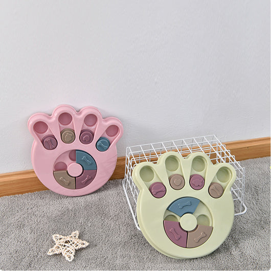 Paw-shaped dog puzzle feeder toy in light yellow with colorful sliding covers, filled with kibble. - Image 4
