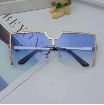 Frameless conjoined sunglasses with gold metal frame and braided detail, featuring brown gradient lenses. - Image 16