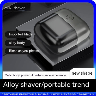 Silver mini electric shaver with a double-headed rotary design and a black power button on top. - Image 3
