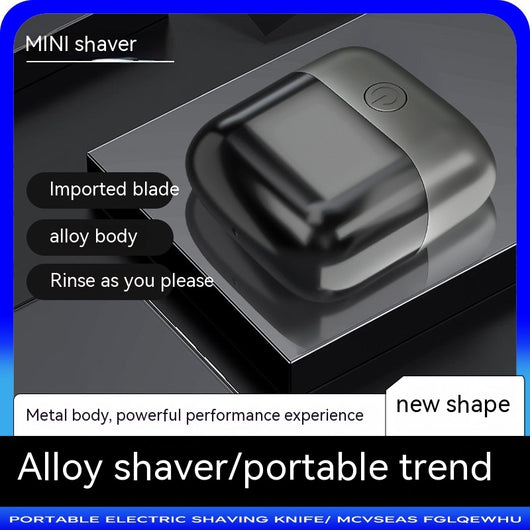 Silver mini electric shaver with a double-headed rotary design and a black power button on top. - Image 3