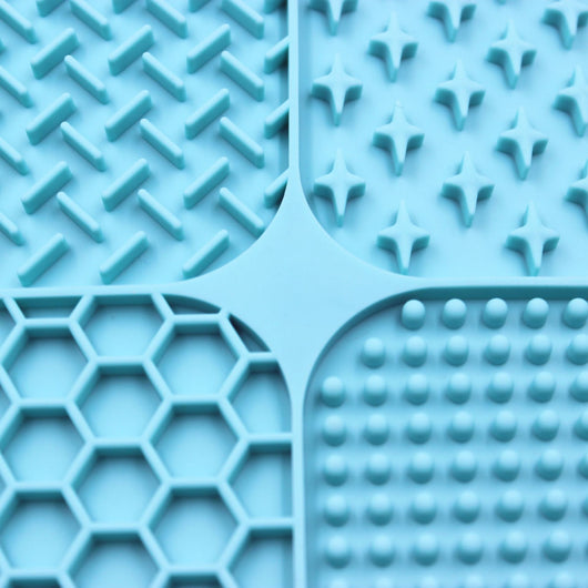 Gray silicone pet licking pad with four textured sections, designed for slow feeding and anti-choking. - Image 3