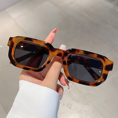 Black square-frame sunglasses with thick, angular frames and dark blue lenses, shown on a white background. - Image 25