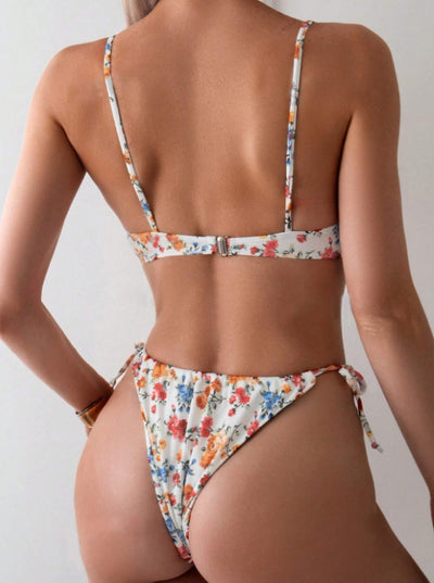 Women's white floral two-piece bikini with red, orange, and blue flowers, featuring a tie-front top and tie-side bottoms. - Image 21