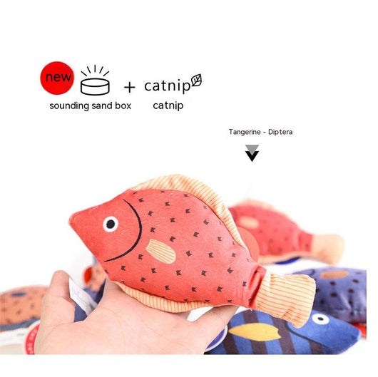Orange fish-shaped plush catnip toy with blue fins and tail, held in a hand, with a small round tag. - Image 15