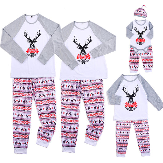 Family matching Christmas pajamas: black long-sleeve tops with white deer prints and red buffalo plaid pants. - Image 5