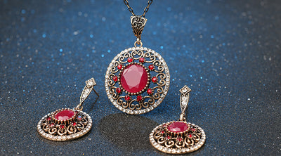 Vintage-style jewelry set with a necklace and matching drop earrings. Features red and clear gemstones in an antique gold-tone filigree design. - Image 11