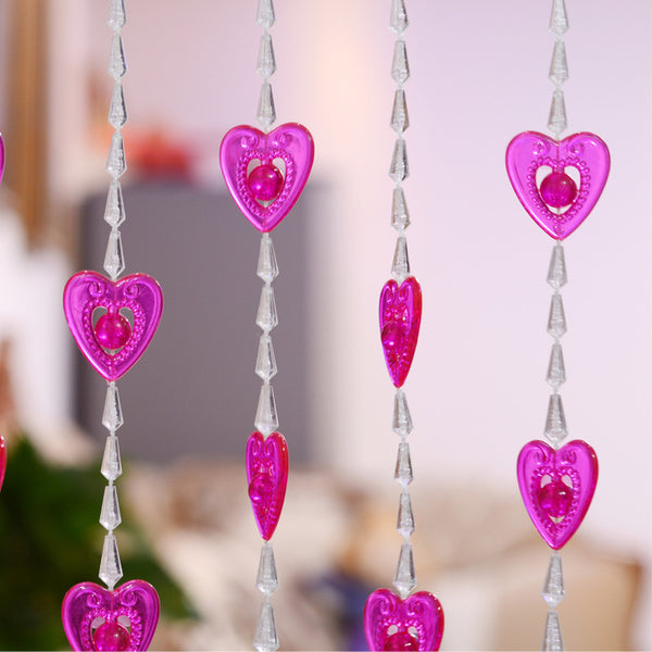 Close-up of a decorative door curtain with alternating red heart-shaped beads and clear faceted acrylic beads. - Image 2