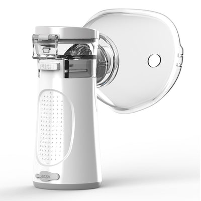 White and blue handheld ultrasonic nebulizer with a clear mask, emitting a blue light, against a bright blue sky. - Image 9