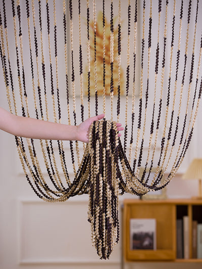 Brown and beige striped string curtain with twisted tassel texture, held by a hand, for living room partition. - Image 21