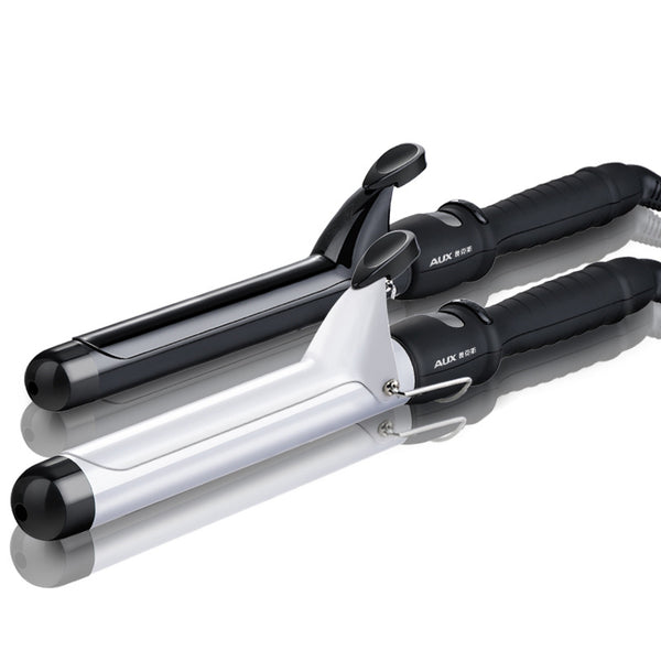 Two AUX curling irons, one black and one white, with ceramic glaze barrels and black handles, on a reflective surface.