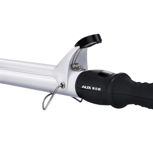 Two AUX curling irons, one black and one white, with ceramic glaze barrels and black handles, on a reflective surface. - Image 3