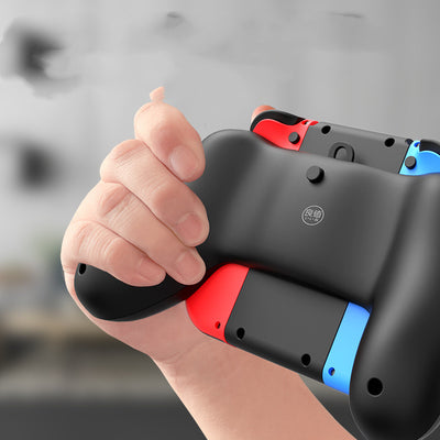 Black charging grip for Nintendo Switch Joy-Cons, shown in packaging and as a standalone unit, with blue and red controllers. - Image 3