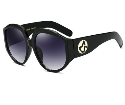 Oversize round sunglasses for women with olive frames, dark gradient lenses, and a gold emblem on the temples. - Image 6