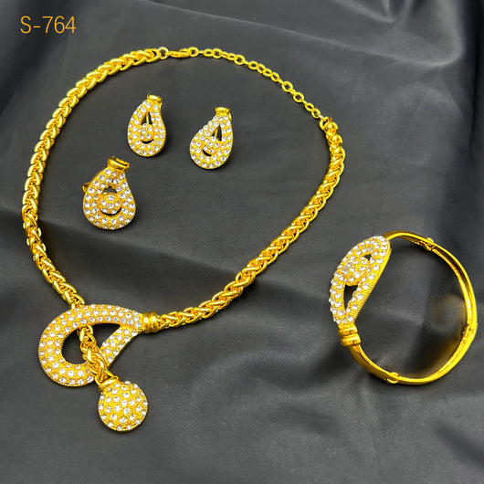 Gold-plated four-piece jewelry set with teardrop rhinestone necklace, bracelet, earrings, and ring on red velvet stands. - Image 10